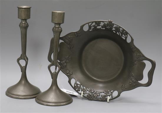 An Art Nouveau Liberty Tudric pewter dish and a pair of pewter candlesticks